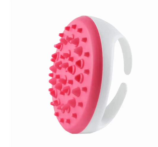 Body massage oil application brush with a pink textured surface for effective skin stimulation and massage.