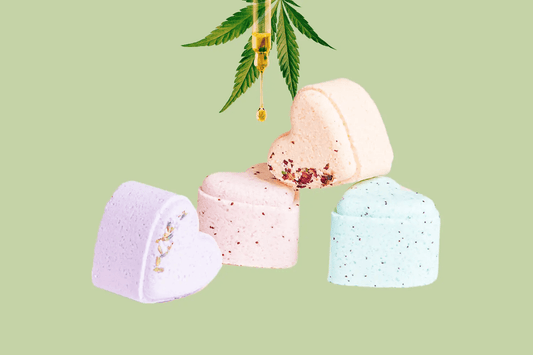 Set of 5 Heart Shaped Shower Steamers with CBD in various colors on a green background, perfect for a spa day.