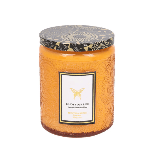 Embossed glass soy candles in an elegant container with a floral lid and label, perfect for aromatherapy and gifting.