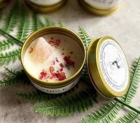 Raw Crystal Scented Candles Gift Box Set displayed with dried flowers and crystal in an elegant tin container.