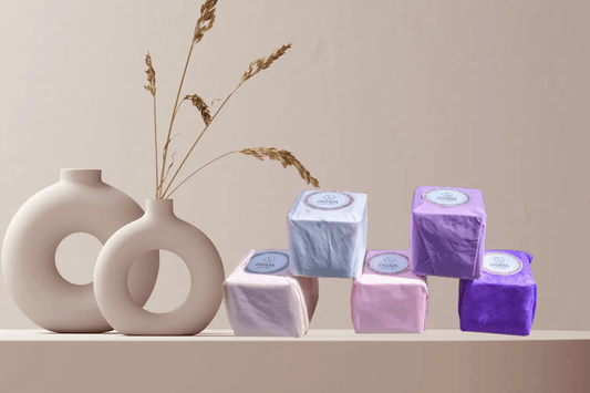 Lavender Shower Steamers Gift Set displayed on a shelf with decorative vases and dried flowers.