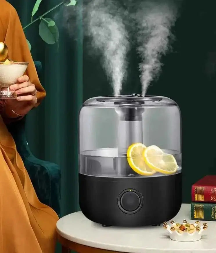 Aromatherapy humidifier with sleek design releasing mist, featuring slices of lemon for enhanced fragrance.