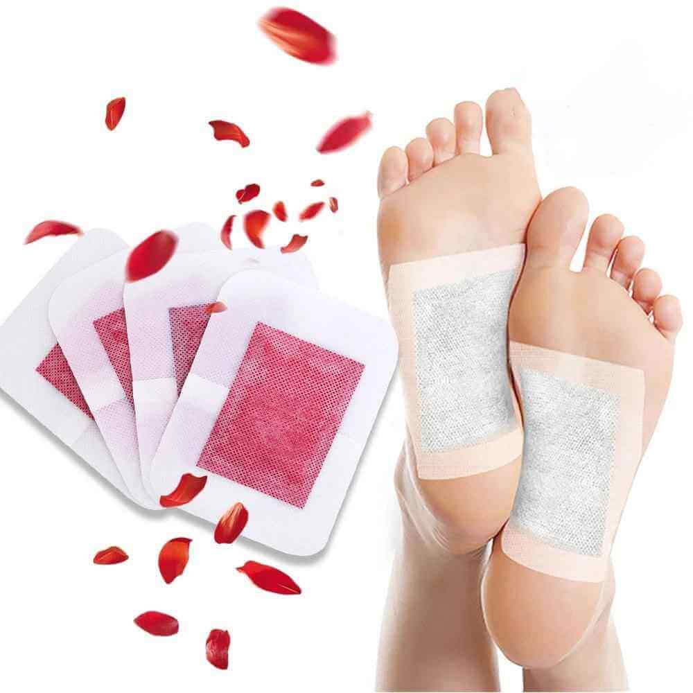 Aromatherapy foot patches placed on feet with petals around, showcasing a rejuvenating foot care experience.