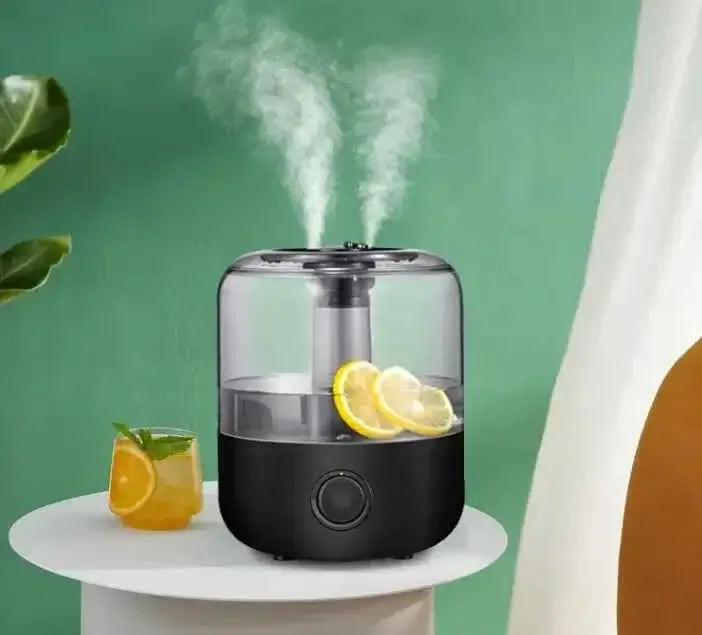 Aromatherapy humidifier with sleek design emitting mist, placed on a table beside a refreshing drink.