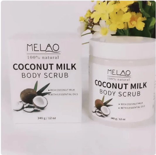 Handmade body scrub featuring Coconut Milk Body Scrub in packaging and jar with floral backdrop.