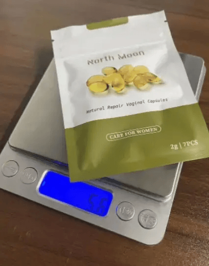North Moon natural repair vaginal capsules on a digital scale, weighing 58 grams.