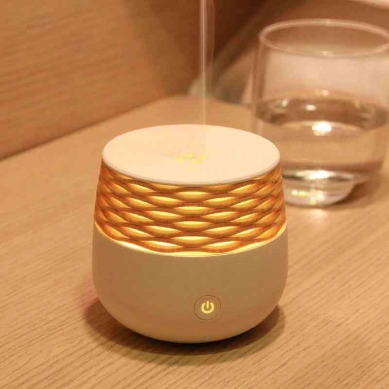Mini Aromatherapy Lamp, Portable Ultrasonic Diffuser exuding soothing scents on a wooden table.
