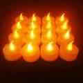 A collection of glowing plastic decorative LED candles arranged in rows, perfect for festive ambiance.
