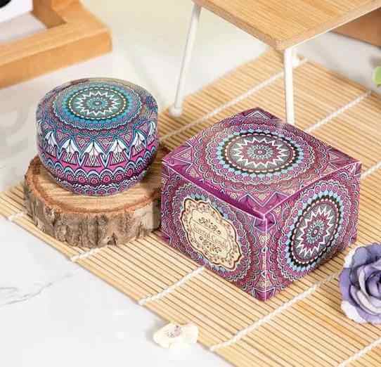 Aromatherapy essential oil candle displayed on a wooden surface, showcasing intricate colorful patterns.
