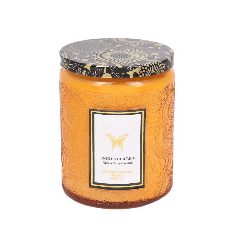 Embossed glass soy candles in an elegant container with a floral lid and label, perfect for aromatherapy and gifting.