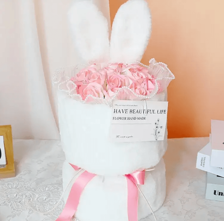 soap flower bouquet gift in a cute bunny-themed arrangement with pink roses and decorative ribbon.