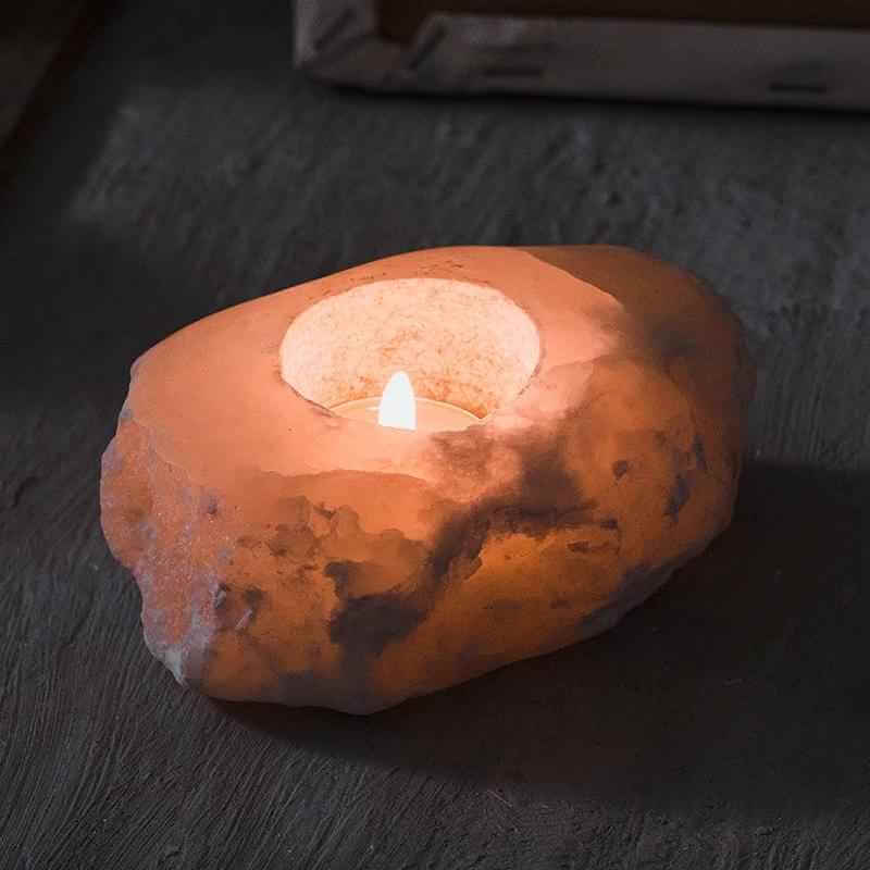 Unique stone aromatherapy candle holder illuminating a warm glow, perfect for stylish home decor.