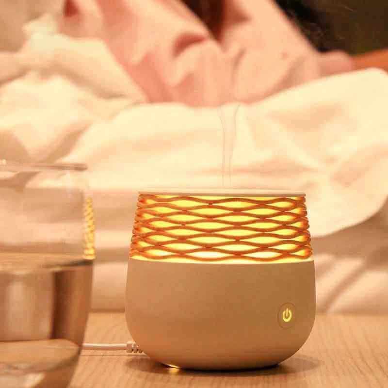 Mini Aromatherapy Lamp as a portable ultrasonic aromatherapy diffuser glowing on a bedside table with water.