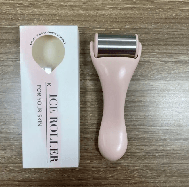 Facial massage tool comprising a pink ice roller and box designed for skincare routines.