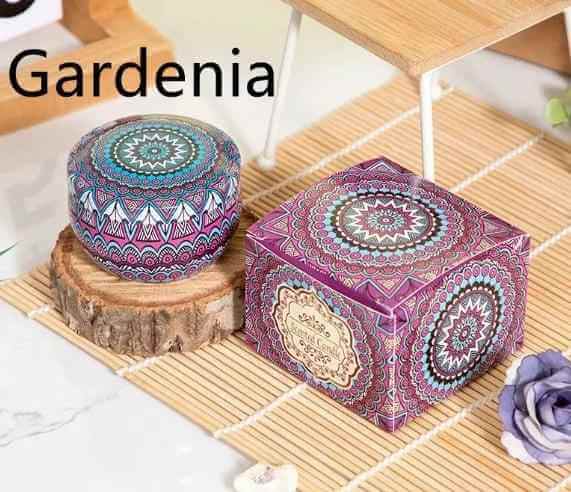 Aromatherapy essential oil candle with gardenia scent, stylishly packaged in vibrant artistic containers.