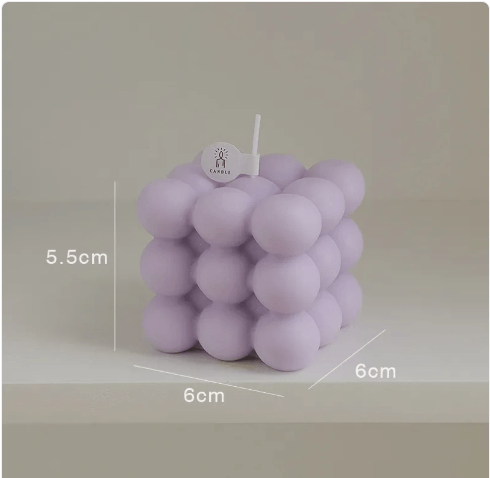 Geometric aromatherapy candle in soft purple, minimalist design, perfect decorative piece for any room.