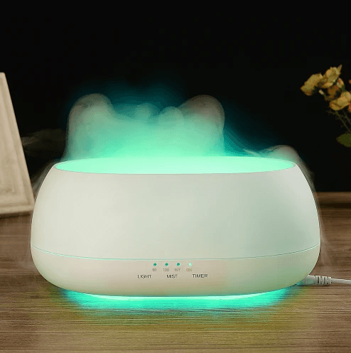 Aromatherapy diffuser humidifier lamp emitting calming mist with soothing green light.