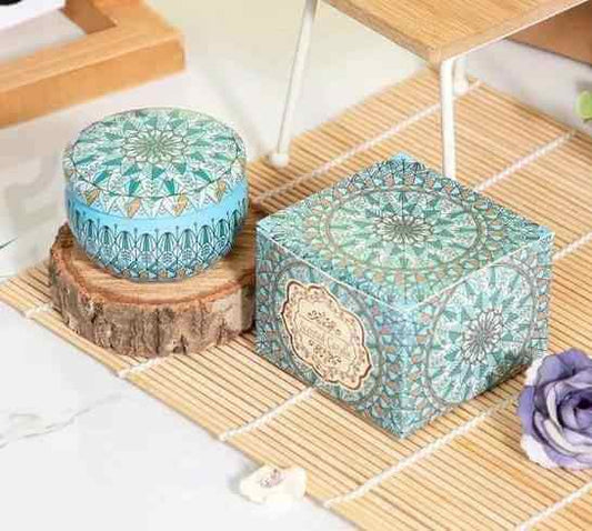 Aromatherapy Essential Oil Candle displayed on a bamboo mat with a decorative box and petal accents.