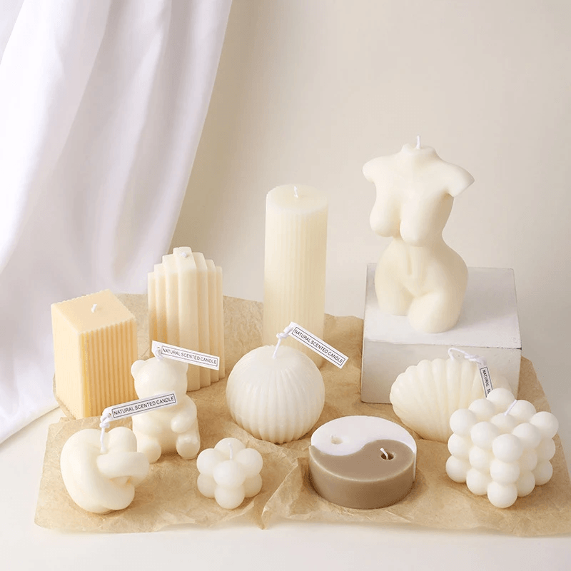 Assorted handmade geometric aromatherapy candles in various unique shapes and sizes.