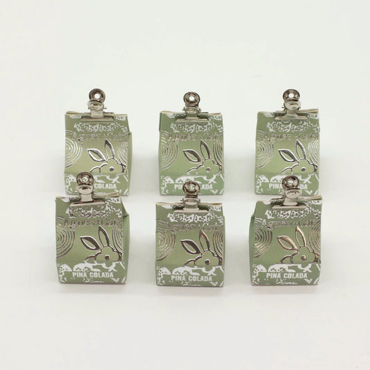 Agnes + Cat Pinacolada lip balm packaging displayed in six units on a white background, showcasing the coconut scent.