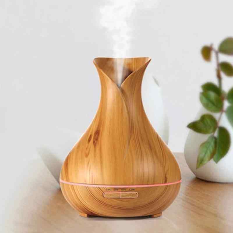 Wood Grain Aromatherapy Diffuser and Humidifier with elegant design releasing mist into the room.