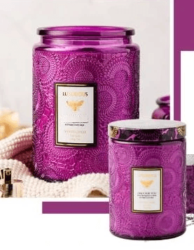 Embossed glass soy candles in elegant purple containers, showcasing luxurious design and aromatic scents.