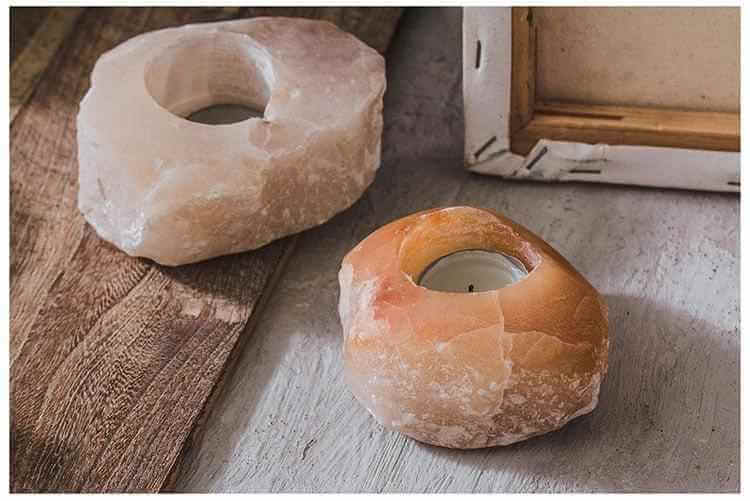 Unique stone aromatherapy candle holder on a wooden surface, showcasing irregular shapes and soft colors.
