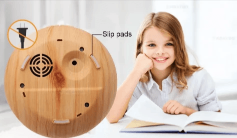 Wood grain aromatherapy diffuser base with slip pads and child smiling, showcasing its design and safety features.