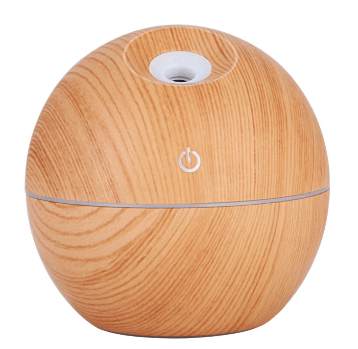 Essential oil diffuser humidifier with a light wood finish, designed for aromatherapy and enhancing ambiance.